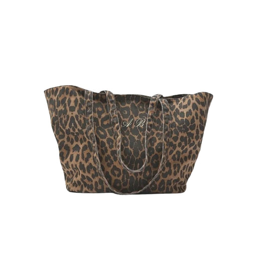 Leopard print handbag with a monogram on a white background